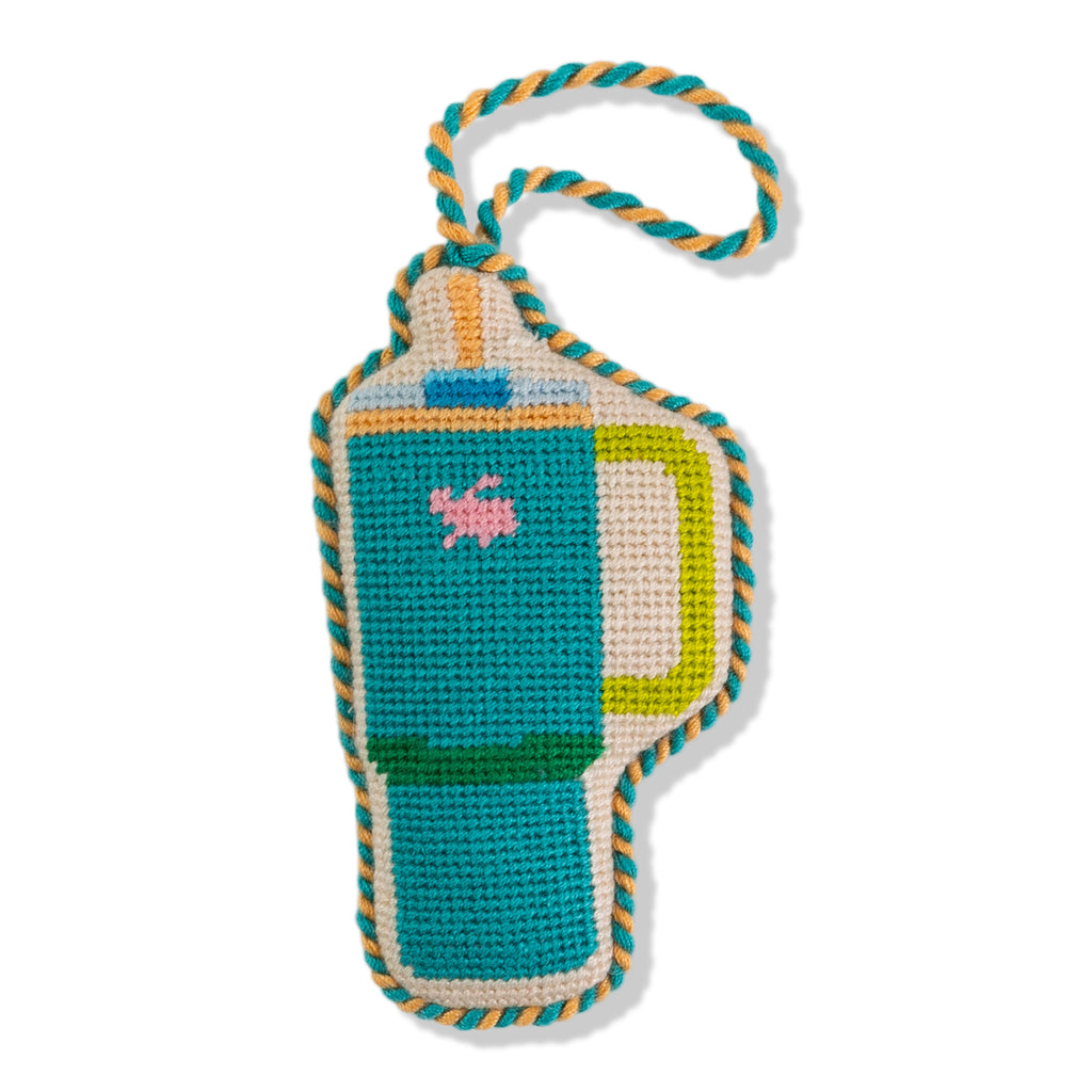 Crocheted dog toy shaped like a water bottle with colorful border on a white background