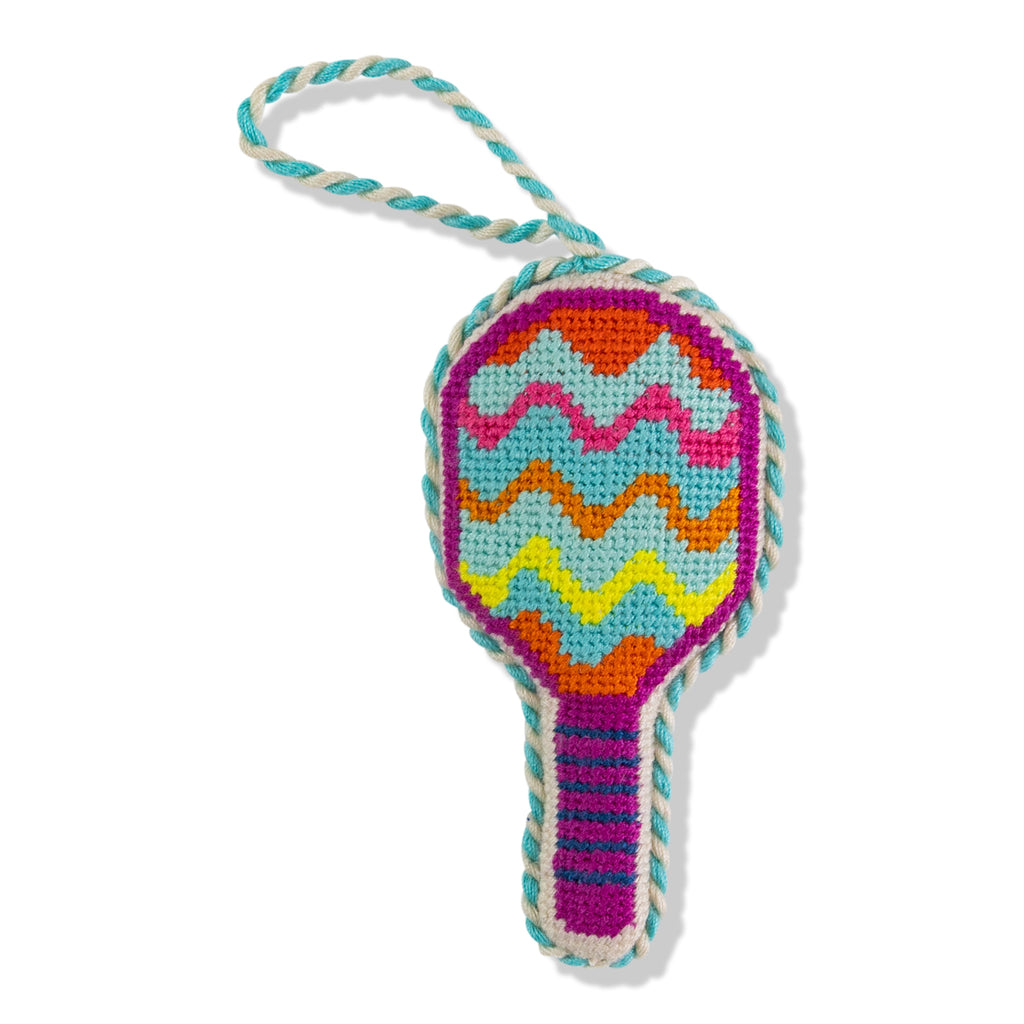 Colorful crocheted toy resembling a tennis racket on a white background