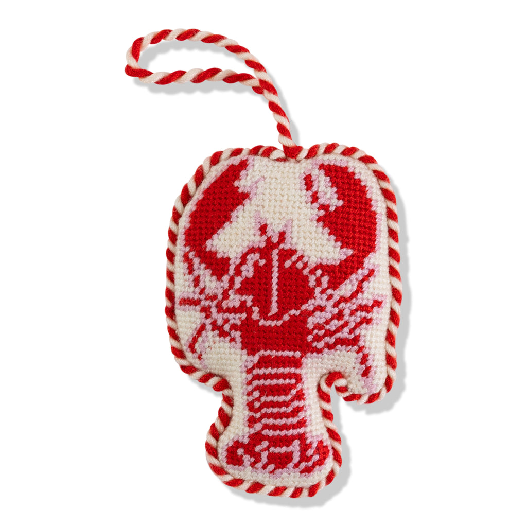 Decorative ornament with red and white candy cane pattern on a white background