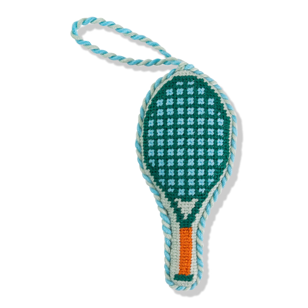 Crocheted tennis racket toy with checkered pattern on a white background