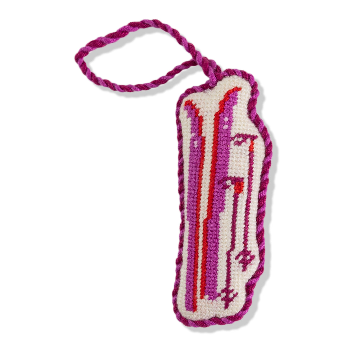 Crocheted bacon-shaped toy with pink and red stripes on a white background