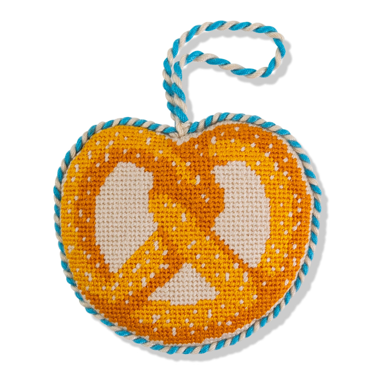 Heart-shaped needlepoint ornament with peace symbol on orange background