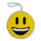 Round yellow smiley face toy with black eyes and mouth, on a white background