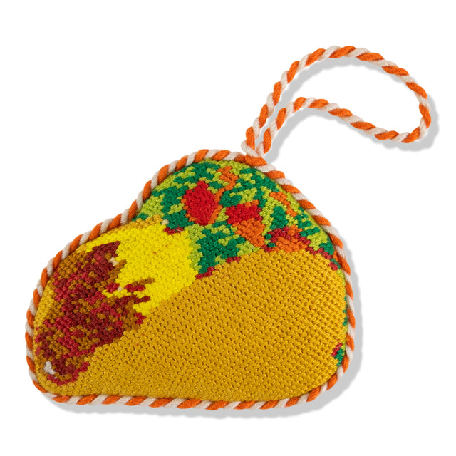 Crocheted taco-shaped toy with a rope on a white background