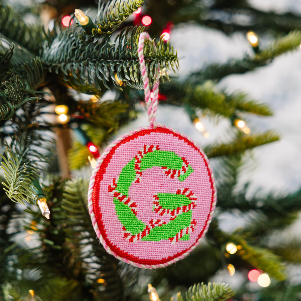Decorative ornament with letter 'G' on a Christmas tree