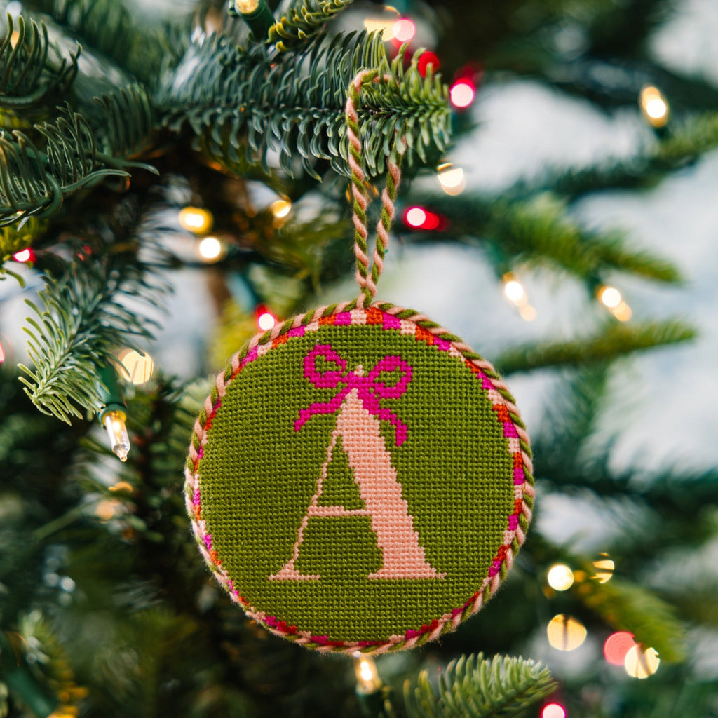 Decorative Christmas ornament with letter 'A' on a tree with lights