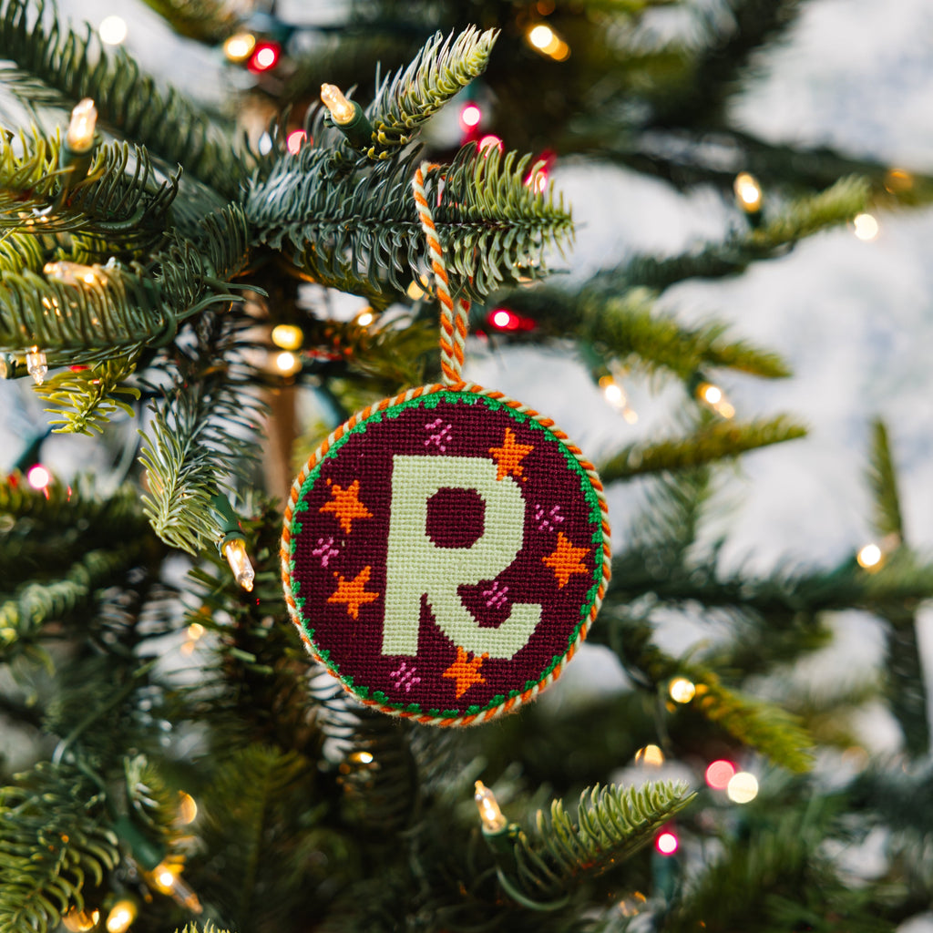 Decorative ornament with a letter 'R' on a Christmas tree