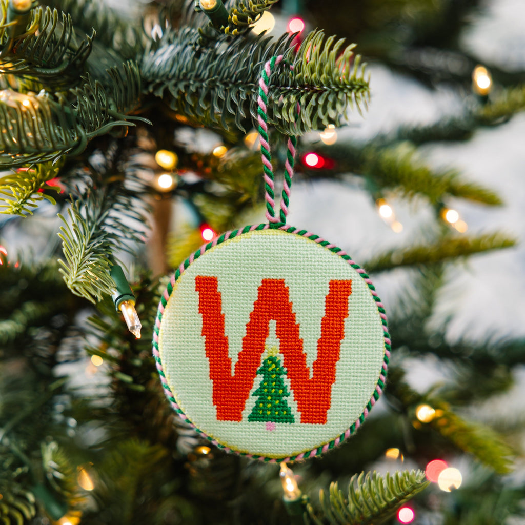 Decorative Christmas ornament with letter 'W' on a tree
