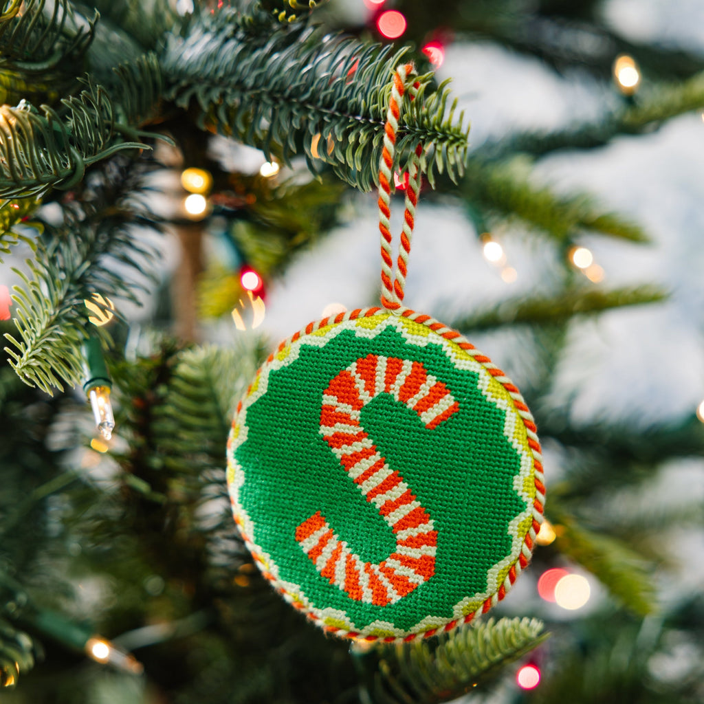Decorative Christmas ornament with candy cane design on a tree