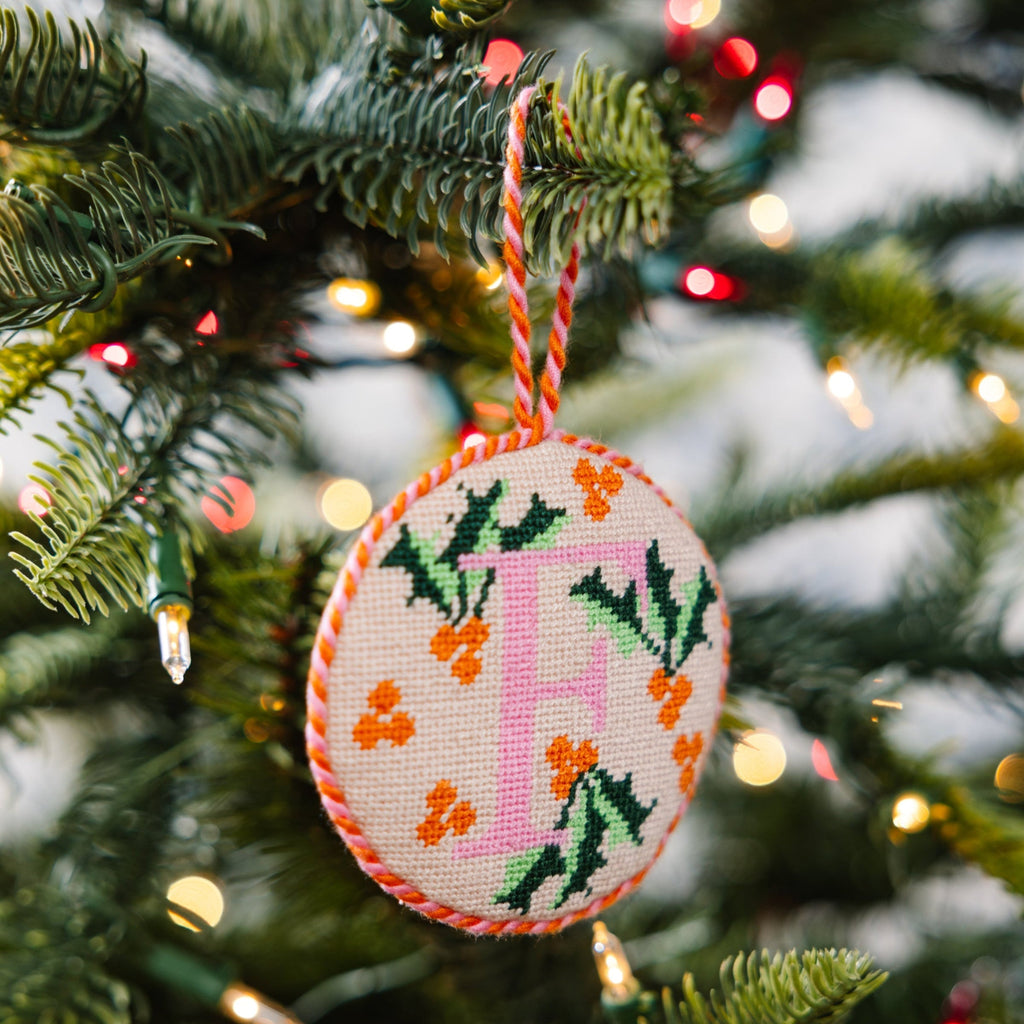 Decorative Christmas ornament with letter 'F' on a Christmas tree.