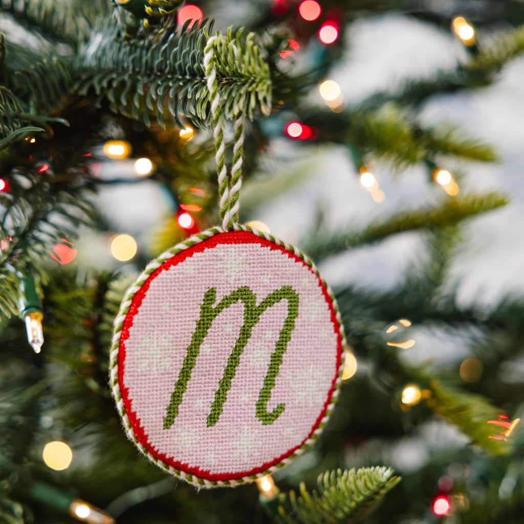 Decorative ornament with letter 'm' on a Christmas tree