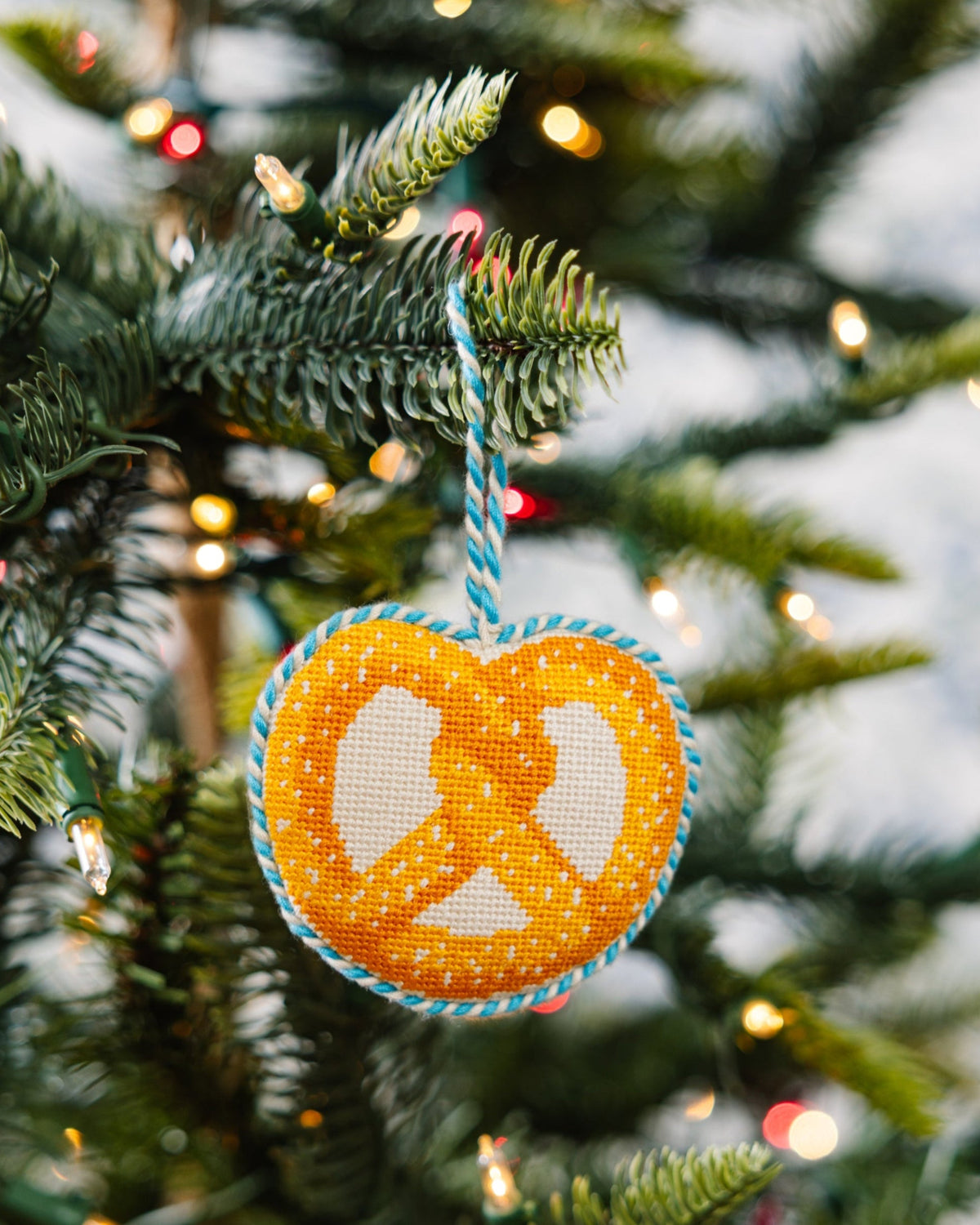 Decorative peace symbol ornament on a Christmas tree with lights.