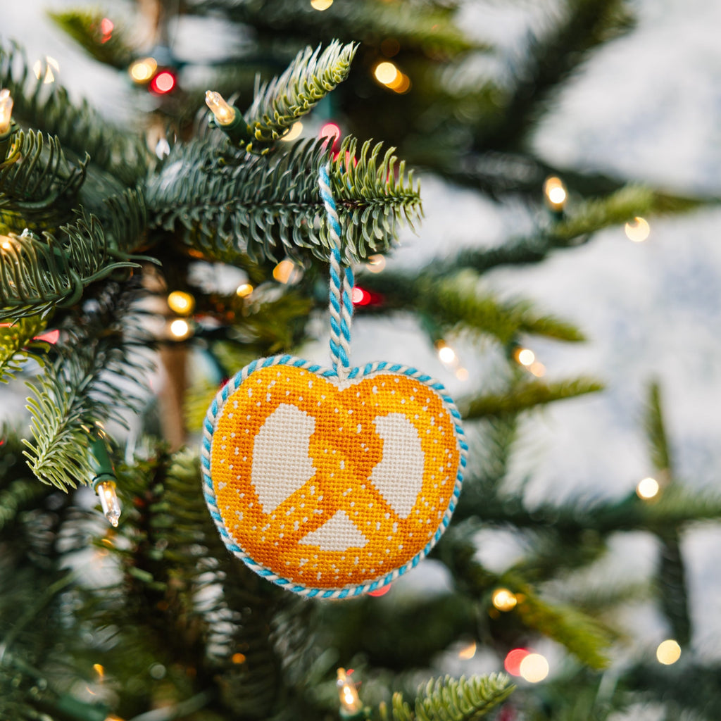 Decorative peace symbol ornament on a Christmas tree with lights.