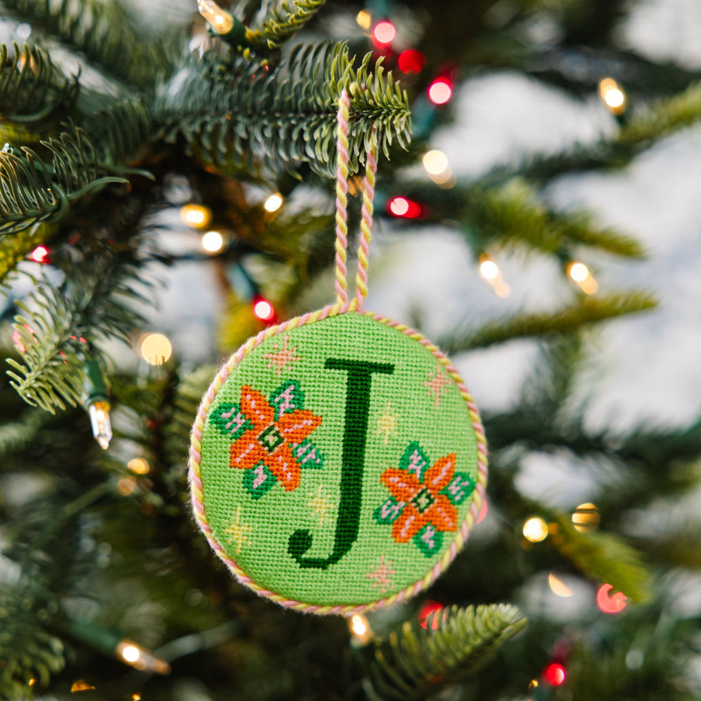 Decorative ornament with letter 'J' on a Christmas tree