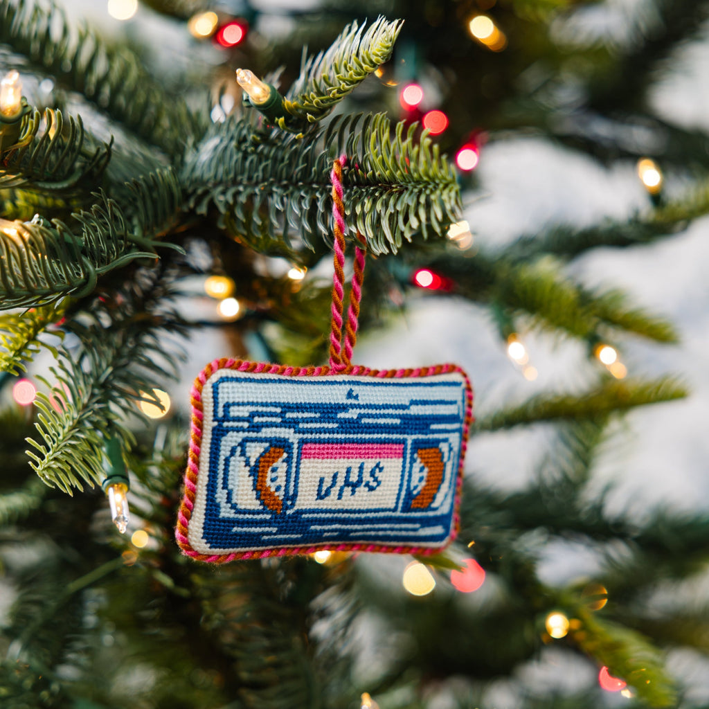 Decorative ornament shaped like a cassette tape on a Christmas tree.