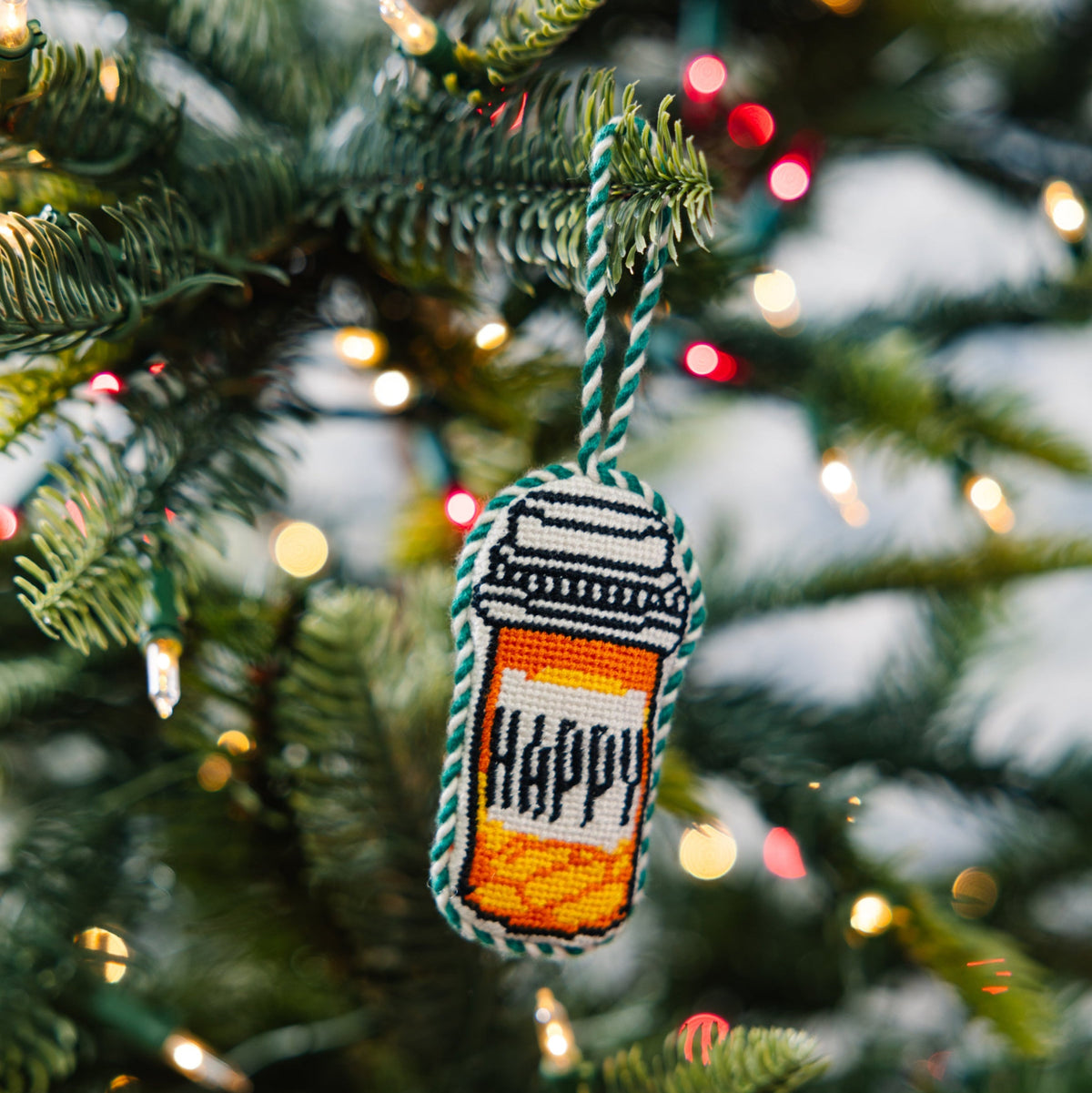 Decorative ornament with 'HAPPY' on a Christmas tree