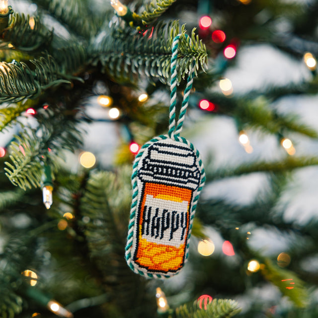 Decorative ornament with 'HAPPY' on a Christmas tree