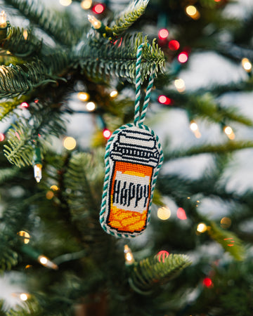 Decorative ornament with 'HAPPY' on a Christmas tree
