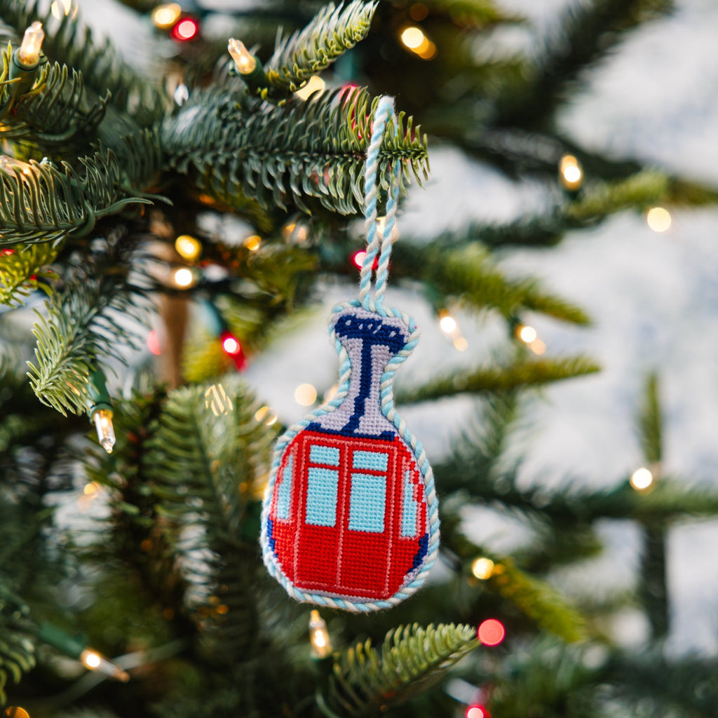 Decorative gondola ornament on a Christmas tree with blurred lights in the background