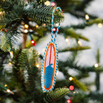 Decorative ornament on a Christmas tree with blurred lights in the background