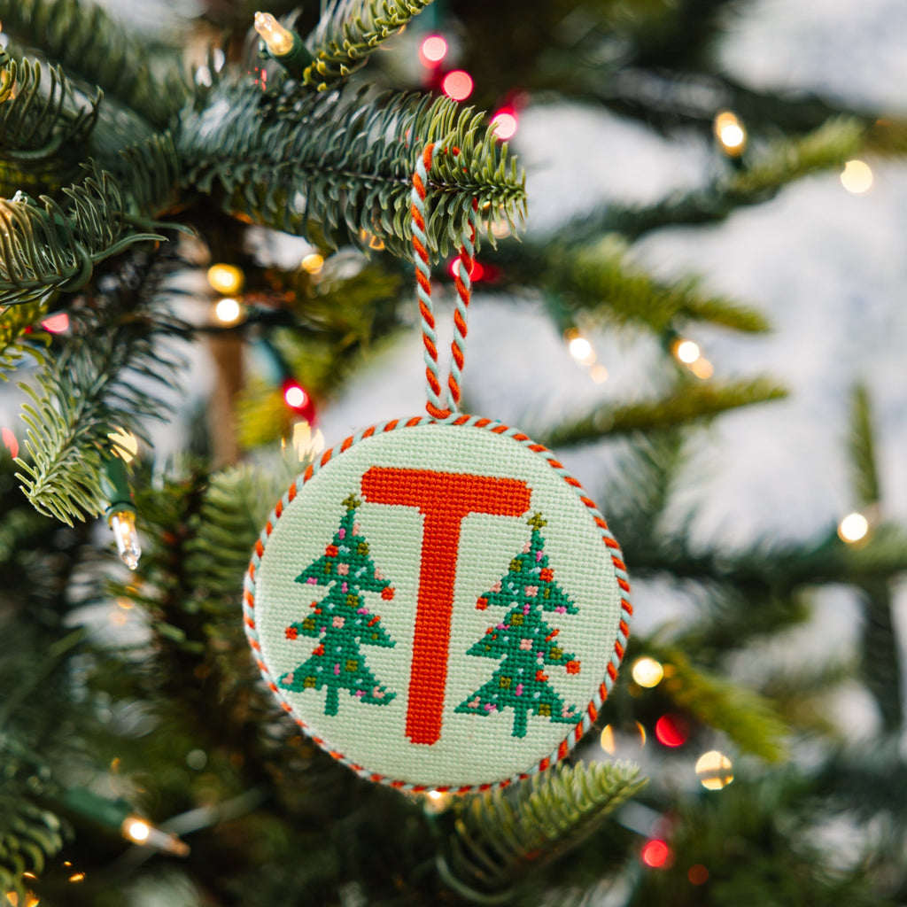 Christmas ornament with letter 'T' on a decorated tree