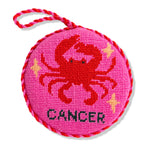 Circular pink object with a crab design and 'Cancer' text on a white background