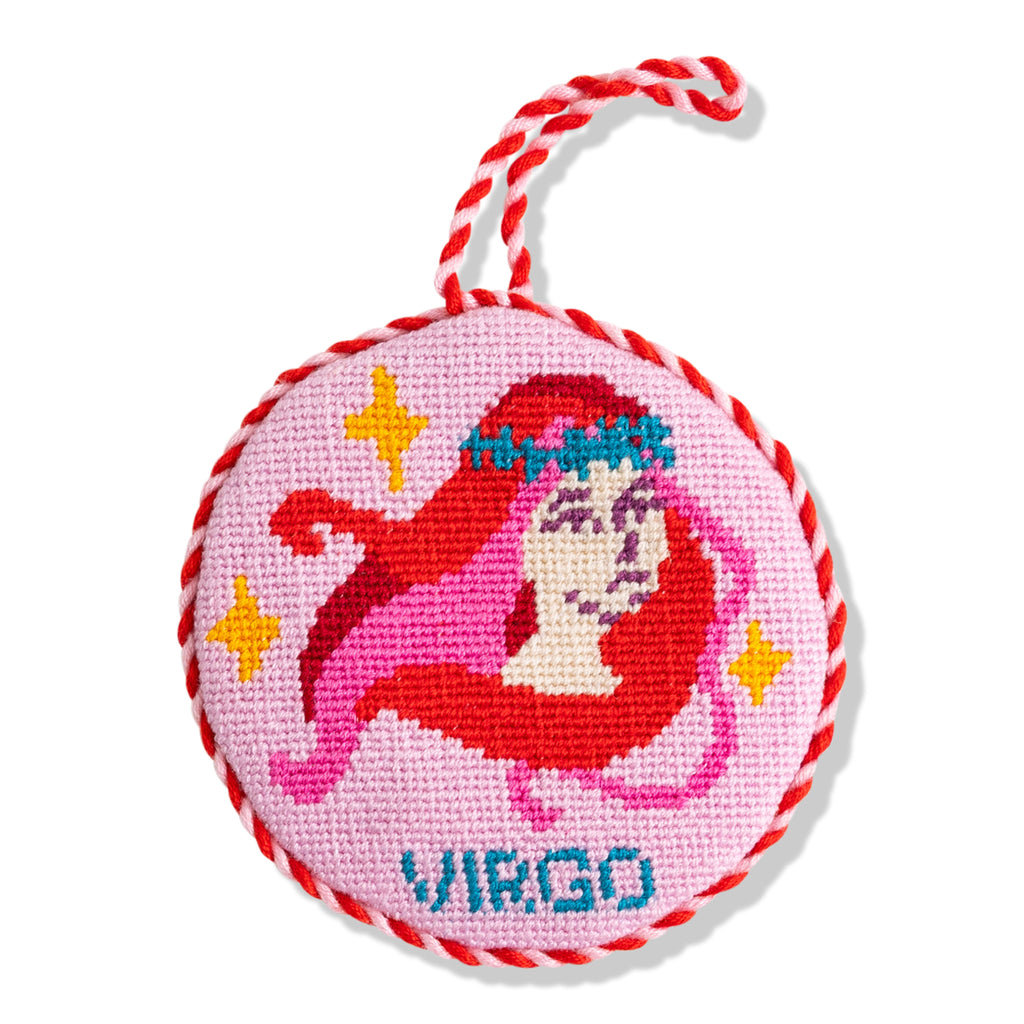 Circular ornament with Virgo zodiac design on a pink background