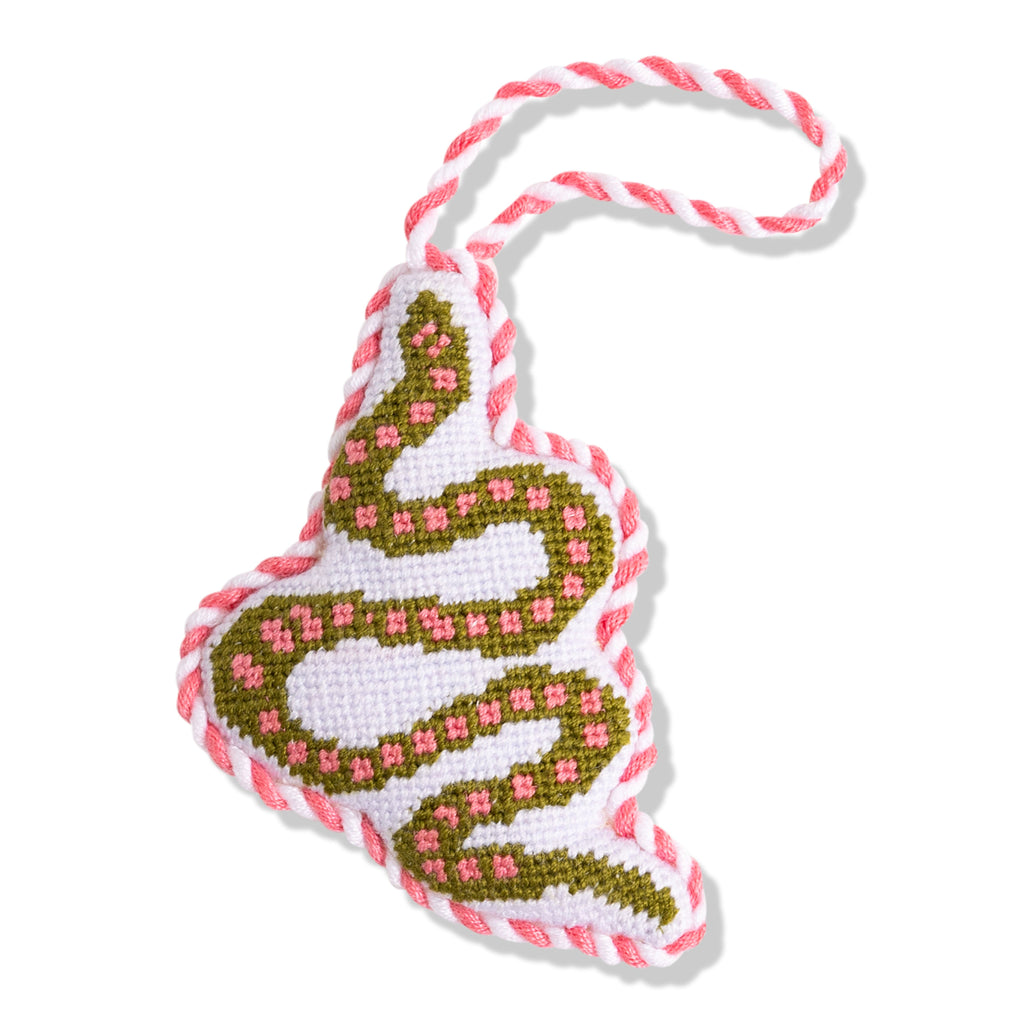 Decorative heart-shaped ornament with pink and green pattern on a white background