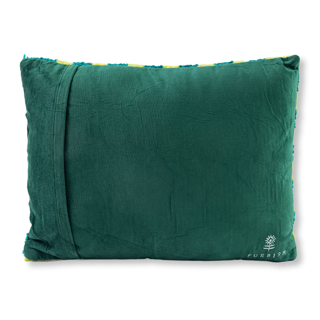 Green pillow with a visible brand logo on a white background