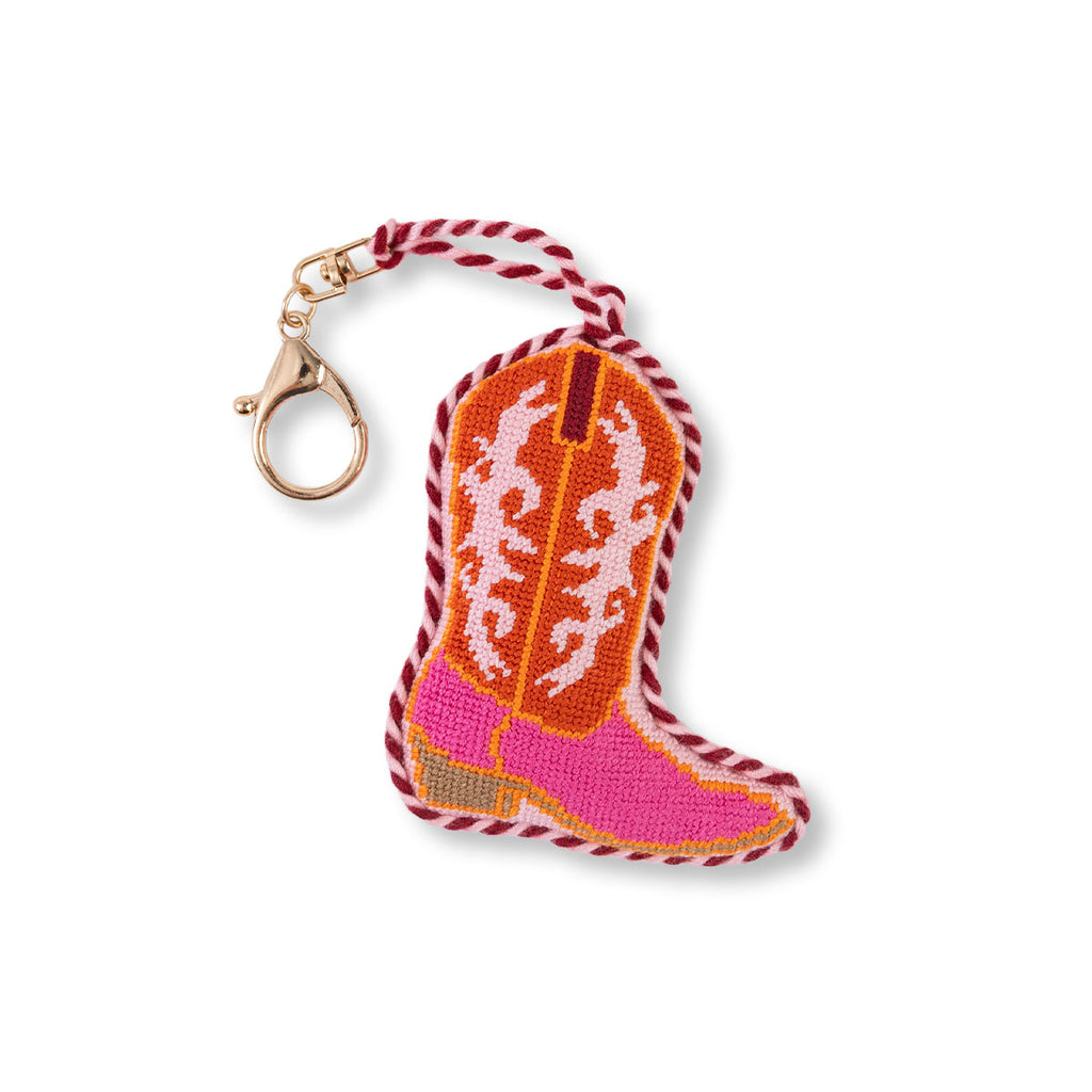 Cowboy boot keychain with pink sole and white pattern on a white background