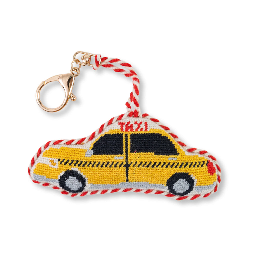 Keychain shaped like a yellow taxi with red and white accents on a white background