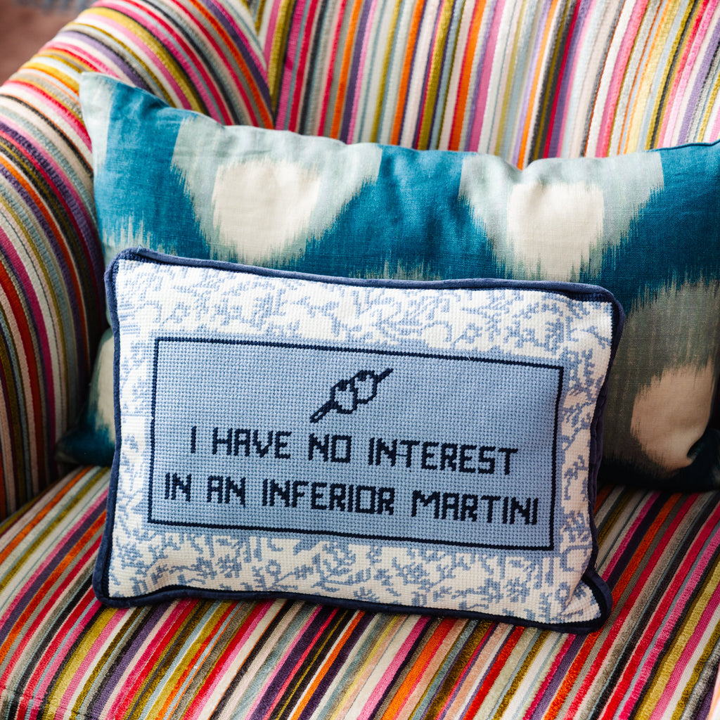 Decorative pillow with text on a colorful striped couch