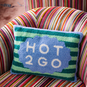 Colorful striped chair with a pillow that says 'HOT 2 GO'.