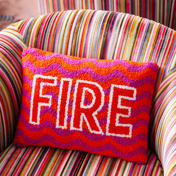 Colorful pillow with 'FIRE' text on a striped chair