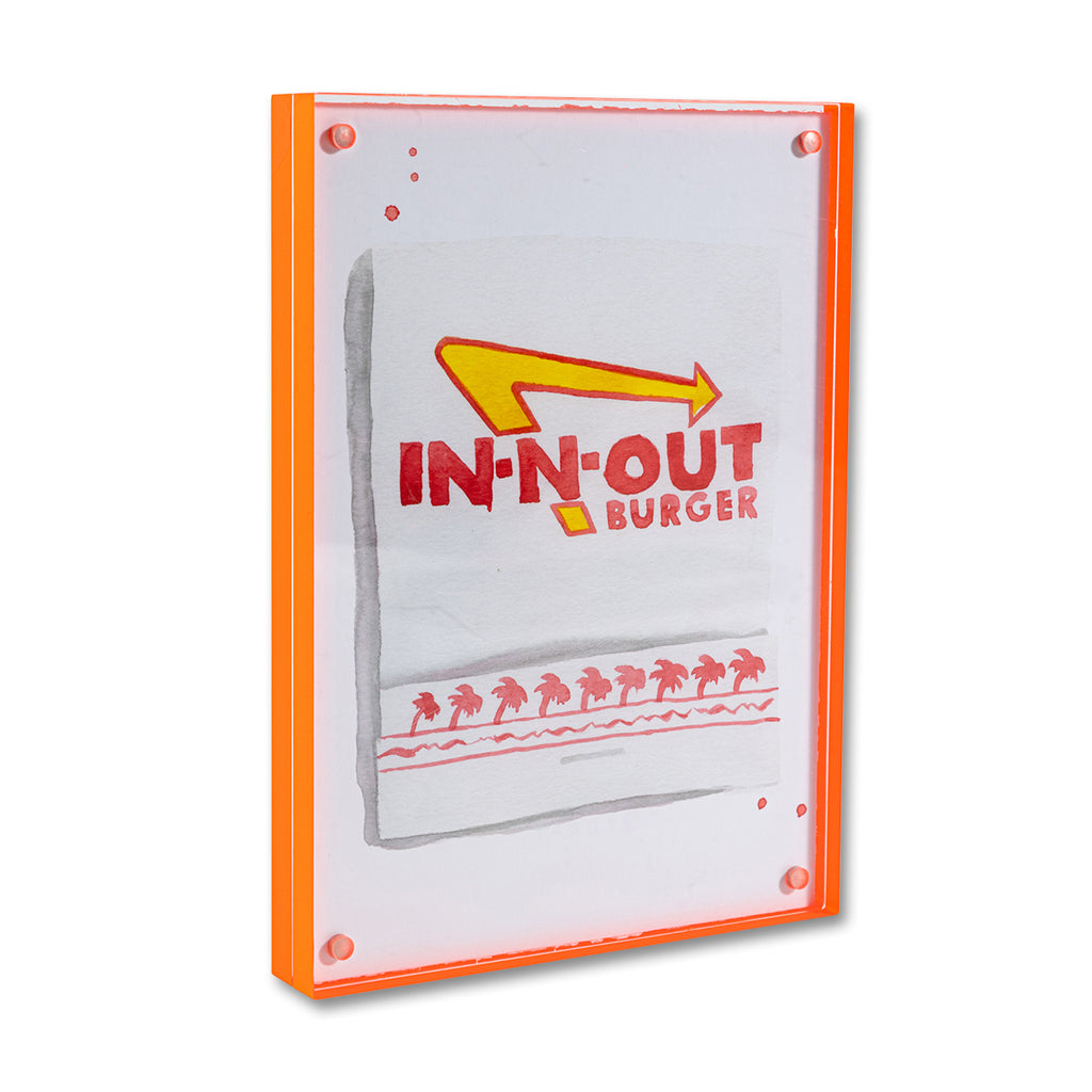 In-N-Out Matchbook - Furbish Studio, An In-N-Out matchbook watercolor print with the restaurant's logo design painted in red and yellow and some palm trees underneath enclosed in a 5" x 7" orange magnetic acrylic floating frame
