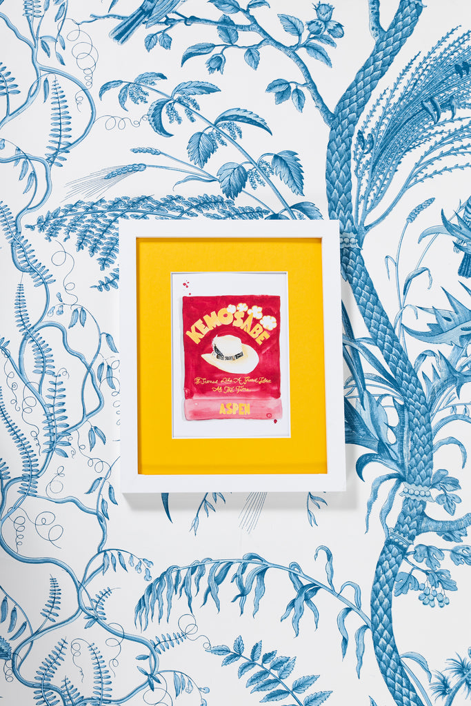 Kemosabe Matchbook - Furbish Studio, An unframed Kemosabe matchbook watercolor print with a red-orange background paint and a hat in the middle in a 5x7 white frame with a wallpaper background