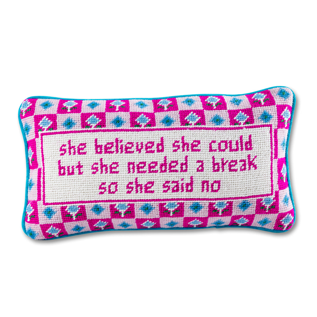 front view of the luxe blue green chic hand needlepoint pillow with "She believed she could but she needed a break so she said no" saying written in pink enclosed by a square shaped pinkish design with pink and blue patterns as its background