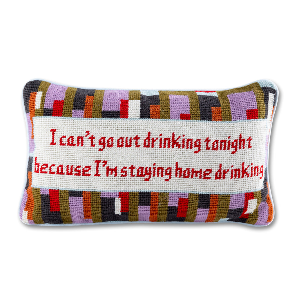front view of the luxe light baby blue velvet chic hand needlepoint pillow with "I can't go out drinking tonight because I'm staying home drinking" saying written in maroon enclosed in a square shaped off-white design surrounded by colorful patterns 