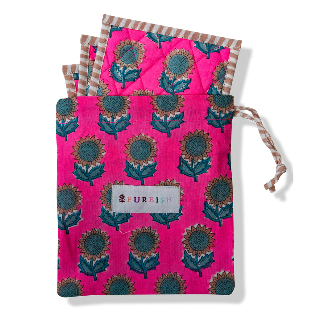 set of pink botanical block print handmade coasters with teal sunflowers and straight edge stripes in a pouch