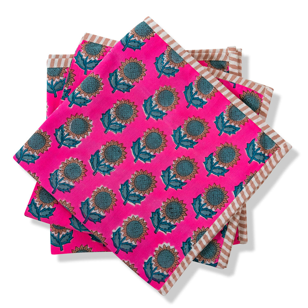 a pink botanical block print handmade napkins with teal sunflowers and straight edge stripes