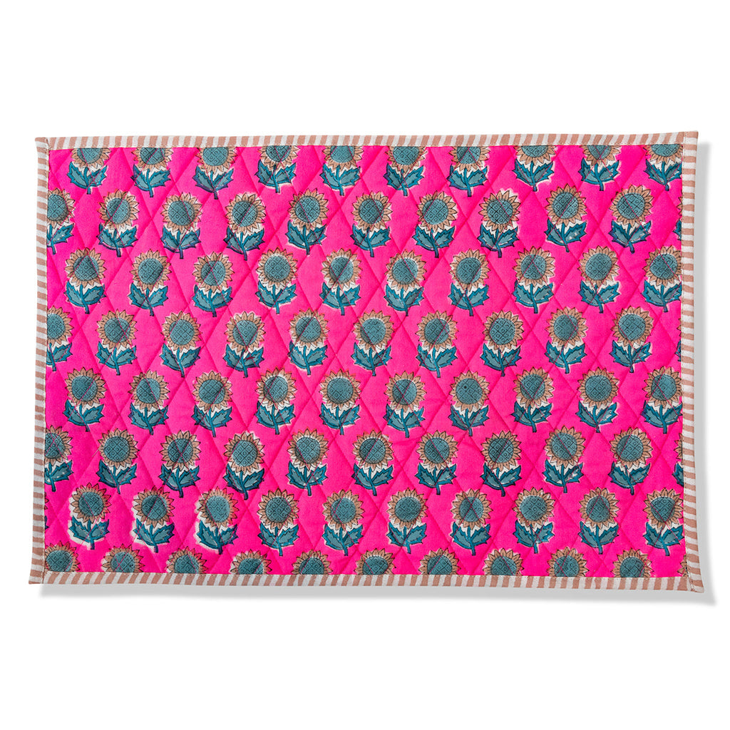an in-depth look of a pink botanical block print handmade placemat with teal sunflowers and straight edge stripes 