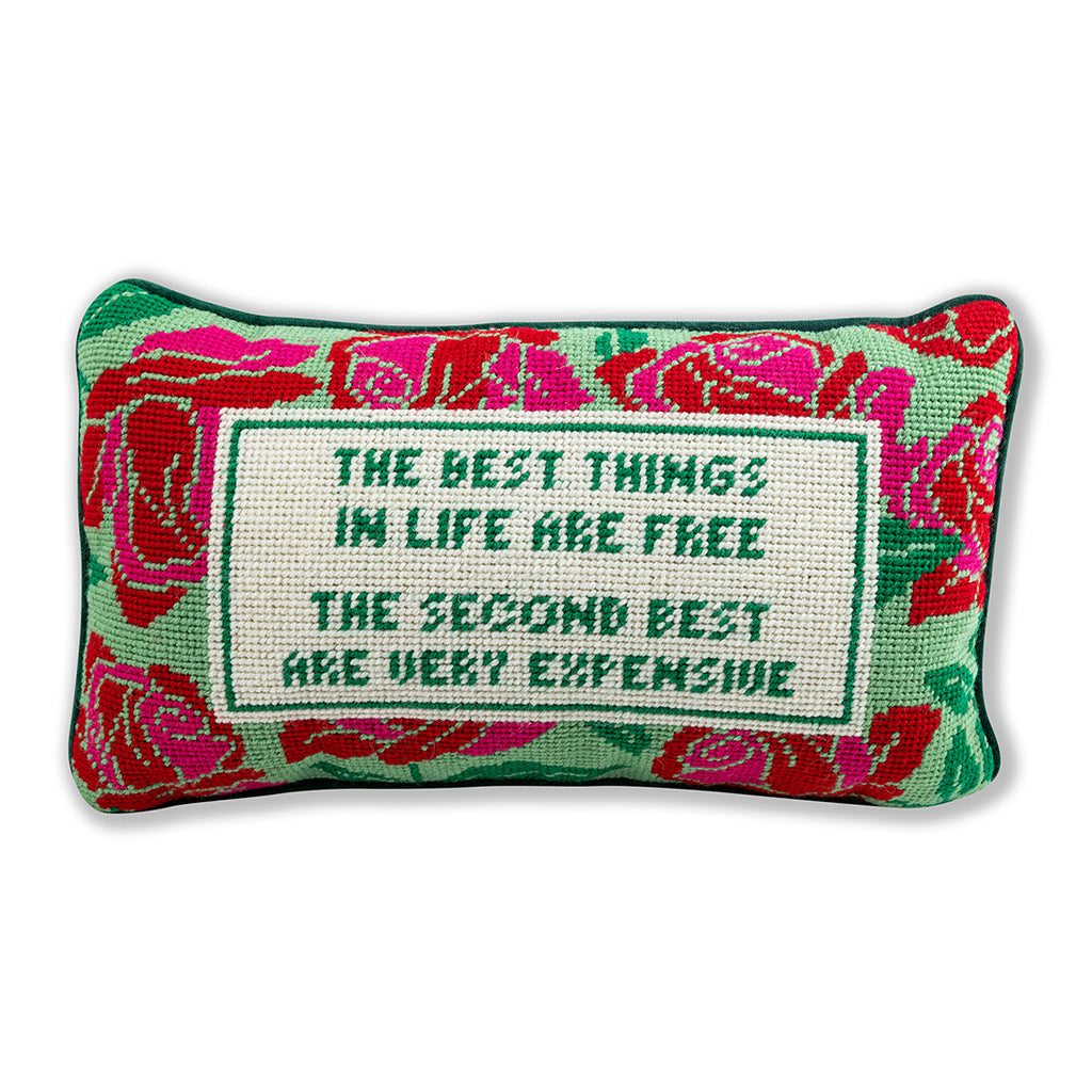 a closer look of a hand embroidered in wool and backed in luxe green velvet chic needlepoint pillow with "The best things in life are free, The second best are very expensive" cheeky saying in front