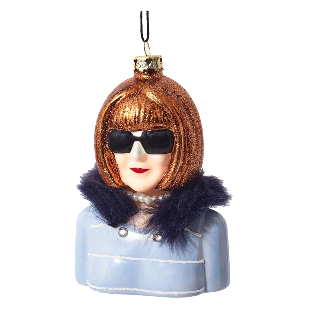 Editor of Vogue, Anna Wintour Christmas tree ornament.  Anna Wintour is wearing a blue tweed jacket with black fur collar and her signature big black sunglasses.